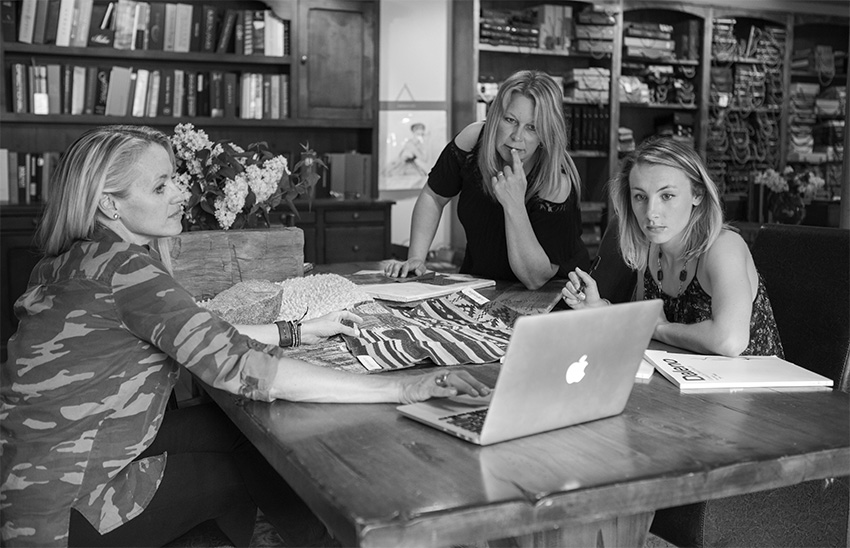 Elizabeth Robb, Dana Talbot, and Linnaea Keane working on a design project at the Elizabeth Robb Interiors studio