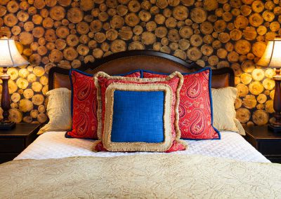 bedroom at the Bozeman Retreat designed by Elizabeth Robb Interiors with wood wallpaper detail