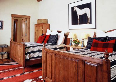 bedroom with two queen beds at the Aspen Ranch designed by Elizabeth Robb Interiors