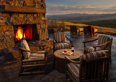 stone patio and outdoor fireplace at the Bozeman Retreat designed by Elizabeth Robb Interiors