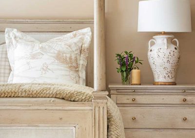 cream colored bed and nightstand of Moonlight residence designed by Elizabeth Robb Interiors
