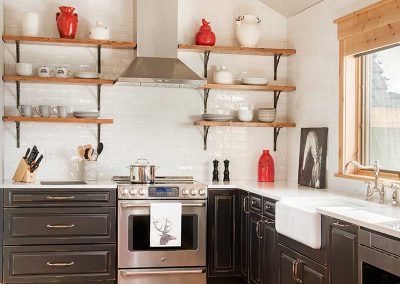 black, white, and red colored kitchen of Moonlight residence designed by Elizabeth Robb Interiors