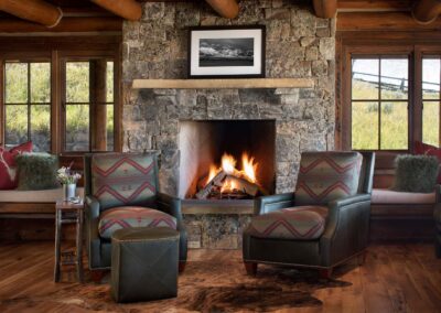 Leather chairs in front of a fireplace