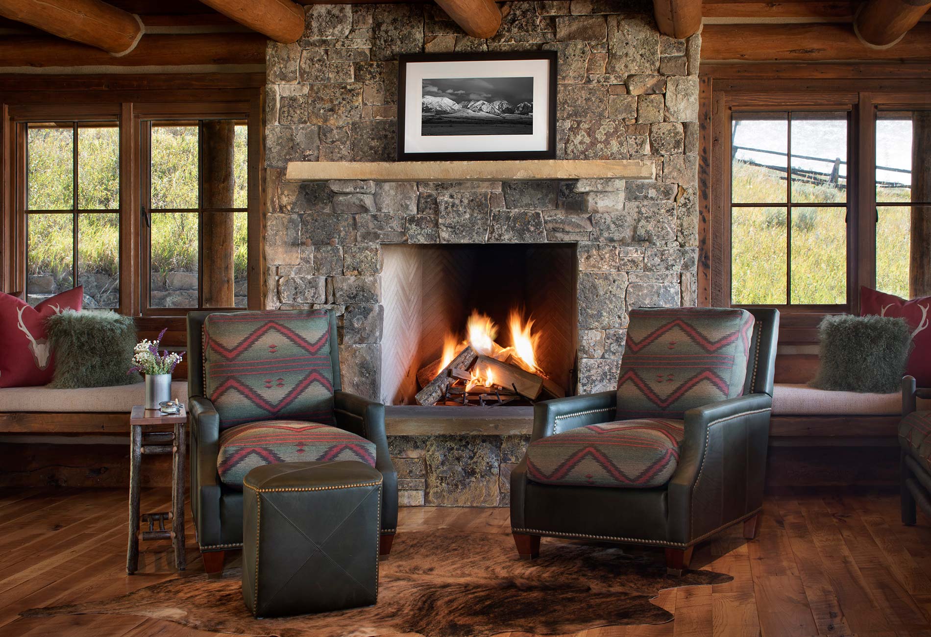 Leather chairs in front of a fireplace